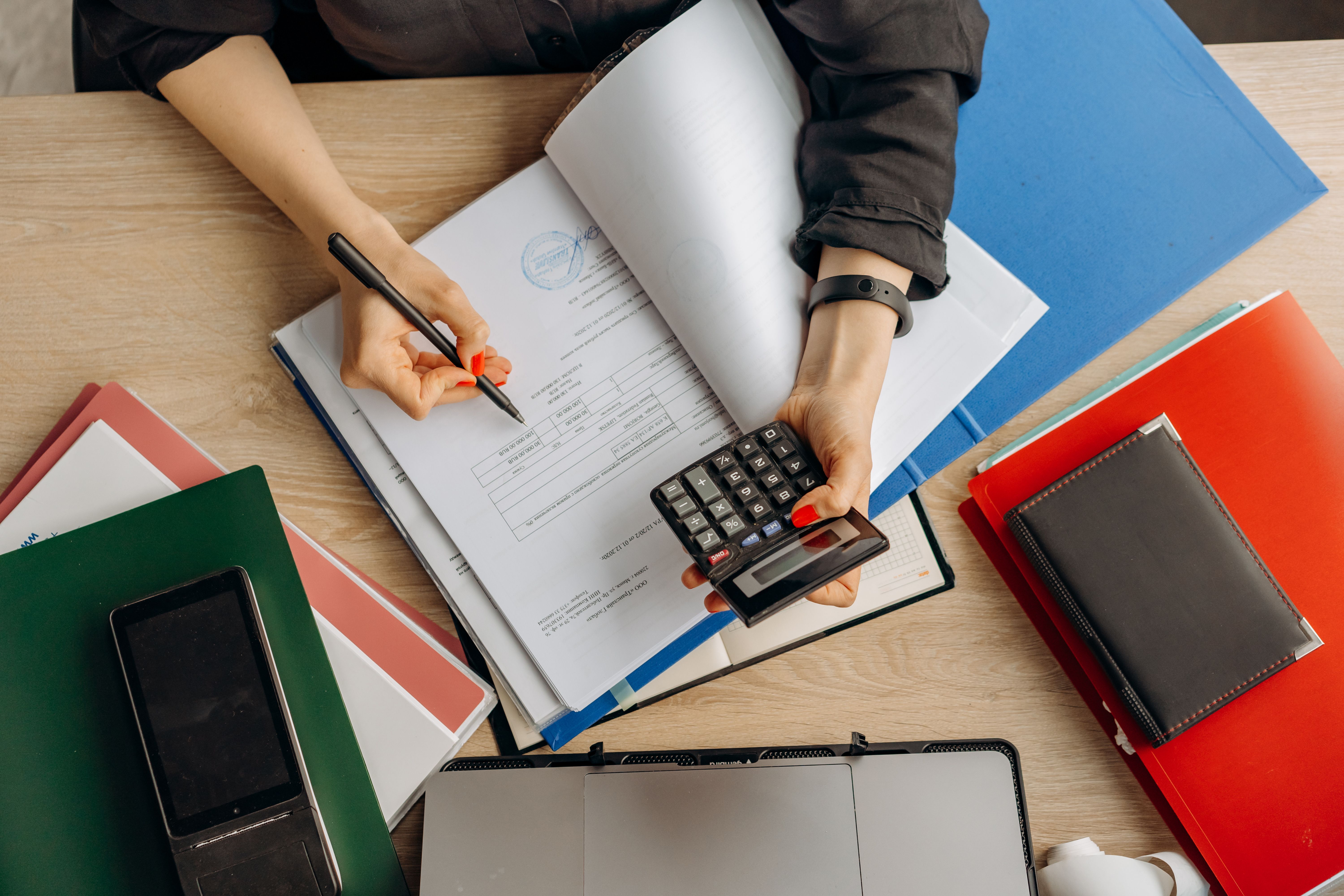 Investment consultant reviewing market charts and portfolio performance data with a client